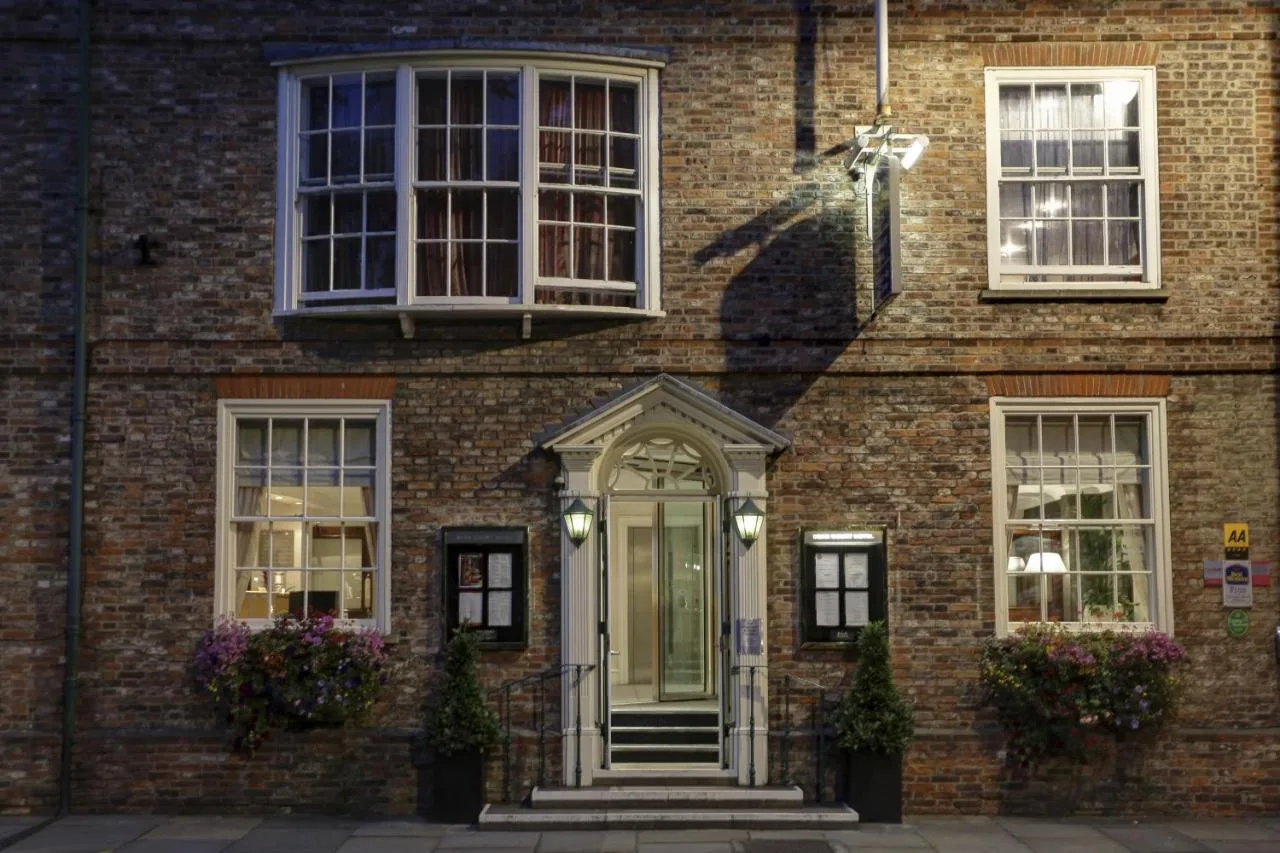a brick building with a white door and windows at The Dean Court in York