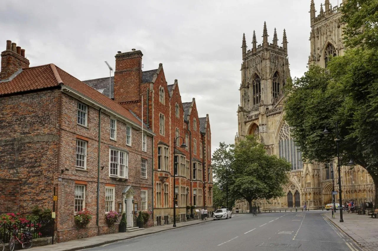 a city street with buildings and a cathedral at The Dean Court in York