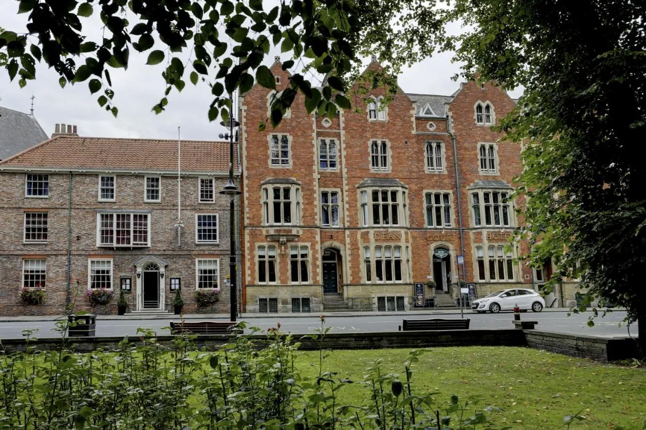 a large brick building with a car parked in front at The Dean Court in York