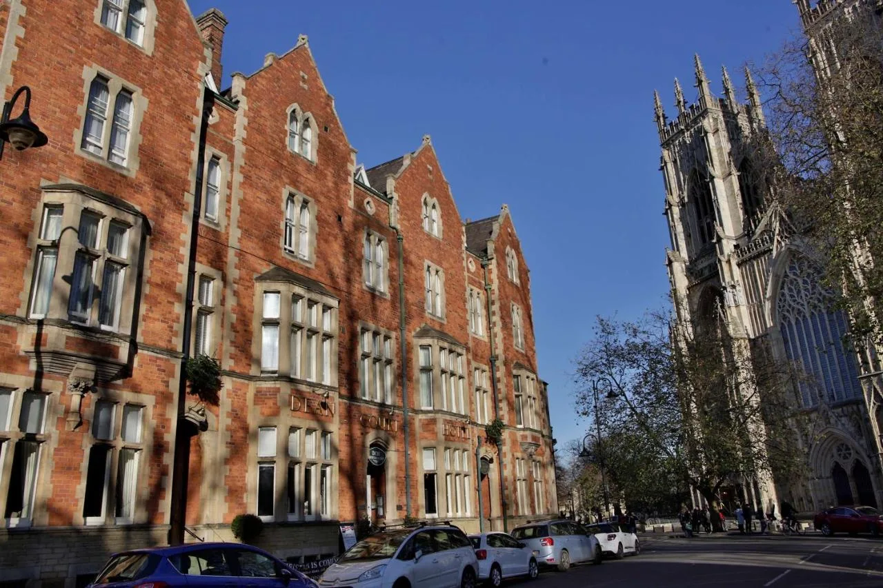 a large red brick building with a clock tower at The Dean Court in York
